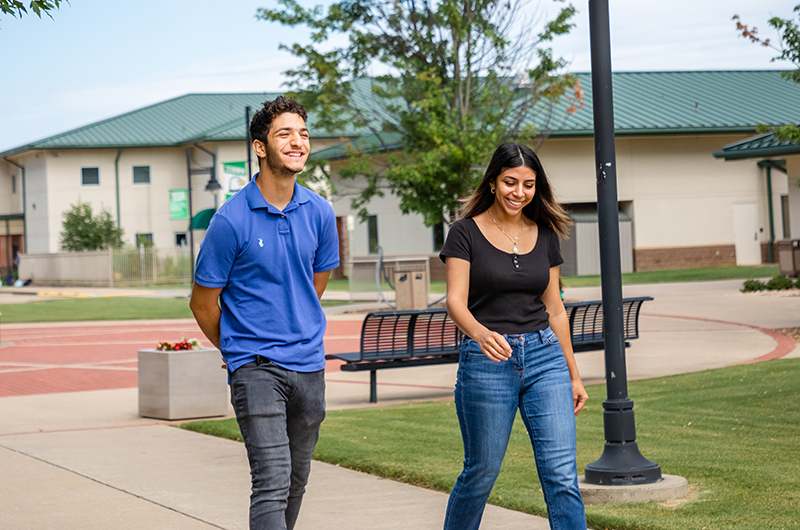 Two Students Walking Outside